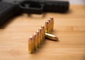 9mm bullets in a row with a gun Royalty Free Stock Photo