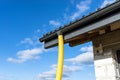 100mm diameter yellow PVC pipe connected to the end of the gutter on the roof, protected against water.