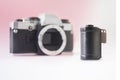 35 mm Film Canister on Blurry SLR Camera Background Royalty Free Stock Photo