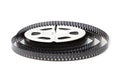 8mm film reel with film strips scattered around. Royalty Free Stock Photo