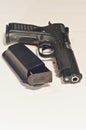9-mm hand gun with a black leather holster containing an extra 9-mm magazine Royalty Free Stock Photo
