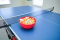 White and orange ping pong ball on ping pong table