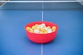 White and orange ping pong ball on ping pong table