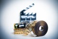 35mm movie reel with out of focus clapper in background Royalty Free Stock Photo