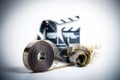 35mm movie reel with out of focus clapper in background Royalty Free Stock Photo