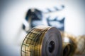 35mm movie reel with out of focus clapper in background Royalty Free Stock Photo