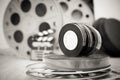 35 mm movie reels with clapper and boxes in background Royalty Free Stock Photo