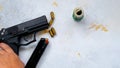 9 mm pistol gun bullets strewn and roll american dollar banknotes on rustic oak table
