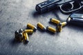 9 mm pistol gun and bullets strewn on the table Royalty Free Stock Photo