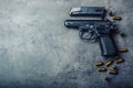 9 mm pistol gun and bullets strewn on the table Royalty Free Stock Photo