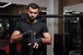 Mma caucasian fighter getting ready for fight, staying on boxing ring, copy space Royalty Free Stock Photo