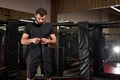 Mma caucasian fighter getting ready for fight, staying on boxing ring, copy space Royalty Free Stock Photo