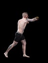 MMA fighter practising punching on black background Royalty Free Stock Photo