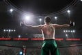 Mma fighter standing in fighting cage