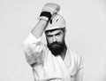 MMA sports concept. Man with beard in kimono and pink helmet on white Royalty Free Stock Photo