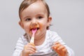 Mmmm...good. a cute little baby sitting in a high chair eating.