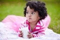 Mmmmm. Adorable little girl drinking milk through a straw while lying on the grass. Royalty Free Stock Photo