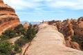 Moab, USA - 06.02.2016: People on a top of sandstone arch in the Arches National Park, Utah, USA. HIking in Utah desert Royalty Free Stock Photo