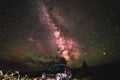 An SUV under the bright Milky Way galaxy stars, Moab Utah