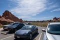 Extremely crowded and busy parking lot, filled with cars at the Devils Garden trail in Arches National