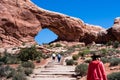 Visitors on a trail to the North Window Arch in the Windows section of Arches National Park