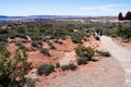 Visitors walking on a trail to the Windows in Arches National Park