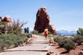 Visitors walking on the Windows trail in Arches National Park