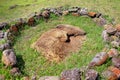 Moai head surrounded by a stone structure at the ceremonial center of Vinapu, on Easer Island.