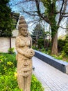 Moai sculpture in a park under a clear blue sky