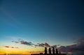 Moai shilouettes in the Ahu Tahai at sunset clear sky