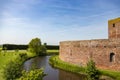 The moat and garden around the ruin castle Teylingen in the South-Holland village of Sassenheim in the Netherlands. On a blue and