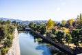 The moat of Nijo Castle with the city of Kyoto in the background and fall colors on the trees Royalty Free Stock Photo