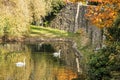Moat with water, swans and ducks in autumn time, vibrant colors
