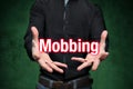 Mobbing, bullying, man holds lettering in the hands Royalty Free Stock Photo