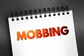Mobbing - sociological term, means bullying of an individual by a group, text on notepad