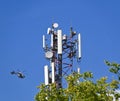Mobil antenna tower and a helicopter in the background Royalty Free Stock Photo