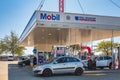 Mobil mart gas service station fuel pumps and the cars in British Columbia Canada