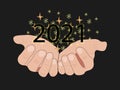 2021 numbers in hands, party glittering confetti isolated on black.
