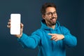 Mobile Ad. Cheerful Young Man Pointing At Blank Smartphone In His Hand Royalty Free Stock Photo