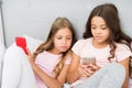 Mobile addicted. Girl play games smartphone online. Pajamas party concept. Happy childhood. Kids surfing internet mobile Royalty Free Stock Photo