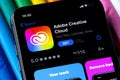 Mobile Adobe creative cloud app on appStore with a colorful plasticine background. Royalty Free Stock Photo