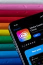 Mobile Adobe creative cloud app on appStore with a colorful plasticine background. Royalty Free Stock Photo