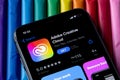 Mobile Adobe creative cloud app on appStore with a colorful plasticine background. Royalty Free Stock Photo