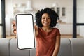 Mobile Advertisement. Happy Black Woman Showing Big Blank Smartphone At Camera