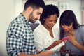 Mobile app developers in their element. a group of young businesspeople having an informal meeting in a modern office. Royalty Free Stock Photo