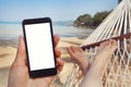 Mobile application for travels, phone in hand, beach Royalty Free Stock Photo