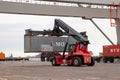 Mobile cargo container handler in action at a shipping container terminal in the Port of Rotterdam, The Netherlands, September 8,