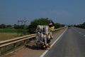 A mobile cart loaded with lots of supplies on a highway