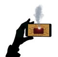 A mobile cell phone has an electronic failure and a chip goes up in smoke Royalty Free Stock Photo