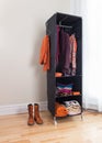 Mobile clothes organizer in a room